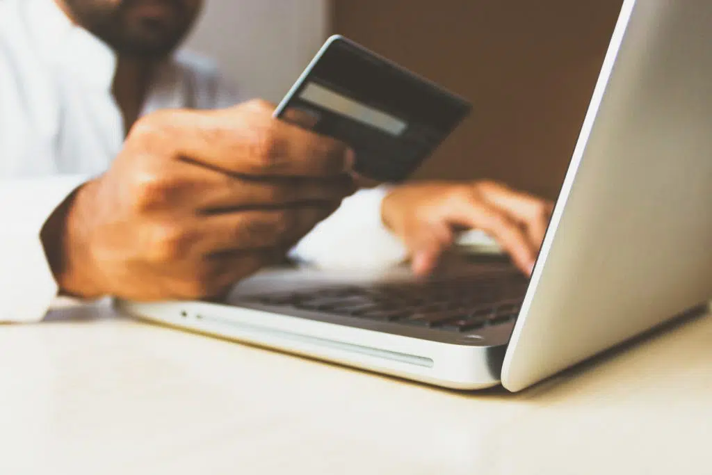 e-commerce customer entering his credit card info on a laptop computer